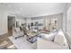Bright, open-concept living room with hardwood floors, modern furnishings, and seamlessly connected kitchen and dining areas at 240 Portrait Way # 87, Indian Trail, NC 28079