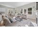 Inviting living room showcasing a fireplace, hardwood floors, a comfortable sofa, and ample natural light at 240 Portrait Way # 87, Indian Trail, NC 28079