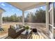 Cozy screened-in patio with comfortable wicker furniture and an outdoor view at 240 Portrait Way # 87, Indian Trail, NC 28079