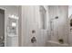 Modern tile shower featuring a built-in seat, rainfall shower head, and adjacent bathroom at 240 Portrait Way # 87, Indian Trail, NC 28079