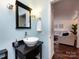 Stylish bathroom with a modern sink, built-in shelving and a view to living room at 308 Queens Rd # 25, Charlotte, NC 28204