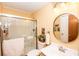 Clean bathroom with a shower, vanity, and a circular mirror at 3510 Flint Dr, Statesville, NC 28677