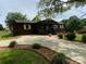 Long driveway to a cozy single-story home with mature landscaping and plenty of parking space at 3510 Flint Dr, Statesville, NC 28677