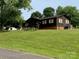 A cozy single-story home sits on a verdant lawn with mature trees providing shade and curb appeal at 3510 Flint Dr, Statesville, NC 28677