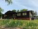 A well-maintained single-story home with a cozy front porch surrounded by vibrant yellow irises at 3510 Flint Dr, Statesville, NC 28677