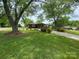 A cozy single-story home surrounded by mature trees and a well-maintained lawn exudes tranquility and charm at 3510 Flint Dr, Statesville, NC 28677