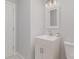 Modern bathroom with a single sink vanity, and updated lighting at 3843 Foxford Pl, Charlotte, NC 28215