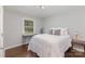 Cozy bedroom with hardwood floors, a bright window, and ample natural light at 3843 Foxford Pl, Charlotte, NC 28215