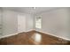 Bedroom with hardwood floors, one window, and a closet at 3843 Foxford Pl, Charlotte, NC 28215