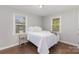 Comfortable bedroom features hardwood floors and bright windows on two sides at 3843 Foxford Pl, Charlotte, NC 28215