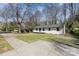 Attractive house with a freshly painted exterior, a new roof, large front yard and sidewalk access at 3843 Foxford Pl, Charlotte, NC 28215