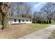 Beautiful home with a well-manicured lawn, new paint and a sidewalk leading to a modern black front door at 3843 Foxford Pl, Charlotte, NC 28215