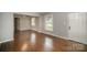 Spacious living room featuring hardwood floors and neutral wall tones at 3843 Foxford Pl, Charlotte, NC 28215