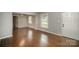 Bright living room featuring hardwood floors and neutral-toned walls at 3843 Foxford Pl, Charlotte, NC 28215