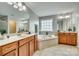 Elegant bathroom with double vanity, soaking tub, and shower at 4376 Foxfield Ct, Harrisburg, NC 28075