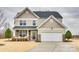 Two-story house with stone accents and a two-car garage at 4376 Foxfield Ct, Harrisburg, NC 28075