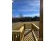 New construction back deck overlooks a spacious and sunlit lawn at 517 W Front St, Statesville, NC 28677