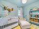 Bedroom with crib, chair, and shelving at 518 Hollis Rd, Charlotte, NC 28209