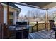 Back deck with grill and wooded backyard view at 5438 Somerset Ln, Harrisburg, NC 28075