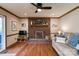 Relaxing living room features a brick fireplace and hardwood floors at 5438 Somerset Ln, Harrisburg, NC 28075