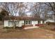 Inviting single-story home featuring classic white siding, black shutters and a welcoming front yard at 550 Brumley Rd, Mooresville, NC 28115