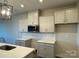 Modern kitchen with white cabinets, quartz countertops, and tile backsplash at 7228 Hodges Meadow Ln, Charlotte, NC 28213