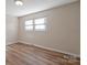 Bright bedroom with wood-look floors and large windows at 760 Bethesda Rd, Statesville, NC 28677