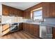 Inviting kitchen with wood cabinets, stainless steel appliances and a sunny window at 760 Bethesda Rd, Statesville, NC 28677