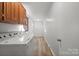 Functional laundry room with washer, dryer, and light wood flooring at 760 Bethesda Rd, Statesville, NC 28677