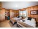 Spacious bedroom with two twin beds, built-in shelving, and large windows at 7740 Robinson Church Rd, Charlotte, NC 28215