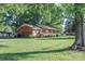 Brick house with an attached garage and large front yard at 7740 Robinson Church Rd, Charlotte, NC 28215