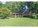 Charming brick home with a welcoming front porch and lush green lawn at 7740 Robinson Church Rd, Charlotte, NC 28215