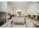 Galley style kitchen with white cabinets and neutral countertops at 7740 Robinson Church Rd, Charlotte, NC 28215
