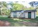 Two storage sheds in a grassy backyard at 7740 Robinson Church Rd, Charlotte, NC 28215