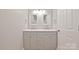 Double vanity bathroom with updated fixtures and gray cabinets at 8800 Crestwood Dr, Mount Pleasant, NC 28124