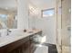 Modern bathroom with double vanity, large mirror, and glass shower at 914 Greenleaf Ave # B, Charlotte, NC 28202