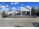 Fenced backyard featuring a covered porch with brick patio and outdoor seating area perfect for relaxing at 1007 Orchid Ln, Fort Mill, SC 29707