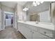 Bathroom with double vanity, walk-in shower, walk-in closet with custom shelving, and tile floors at 1007 Orchid Ln, Fort Mill, SC 29707