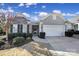 Charming home featuring a gray shingle and brick exterior, a two-car garage, and landscaped front yard at 1007 Orchid Ln, Fort Mill, SC 29707