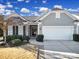 Charming home featuring a gray shingle and brick exterior, a two-car garage, and landscaped front yard at 1007 Orchid Ln, Fort Mill, SC 29707