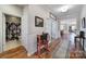 Hallway with hardwood floors, white trim and a view of the open-concept floor plan at 1007 Orchid Ln, Fort Mill, SC 29707