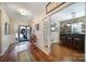 Hallway with hardwood floors and a view of the front door, a bar room with custom counter and stools at 1007 Orchid Ln, Fort Mill, SC 29707