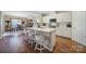 Bright kitchen with white cabinets, stainless steel appliances, granite counters and seating at the island at 1007 Orchid Ln, Fort Mill, SC 29707