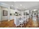 Bright kitchen with white cabinets, stainless steel appliances, granite counters and seating at the island at 1007 Orchid Ln, Fort Mill, SC 29707