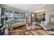 Bright living room with hardwood floors, lots of light, and entry to formal dining room at 1007 Orchid Ln, Fort Mill, SC 29707