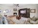 Cozy living room features a fireplace, ceiling fan, and built-in entertainment center at 1007 Orchid Ln, Fort Mill, SC 29707