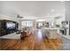 Open concept living room with kitchen island, ceiling fan and hardwood floors at 1007 Orchid Ln, Fort Mill, SC 29707