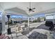 Outdoor seating on a brick patio underneath a covered porch with a ceiling fan and nice backyard view at 1007 Orchid Ln, Fort Mill, SC 29707