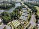 Aerial image of the community's well-maintained tennis and bocce ball courts by a tranquil lake at 1007 Orchid Ln, Fort Mill, SC 29707