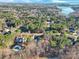 Aerial shot showcasing the community surrounded by lush trees, with a glimpse of the lake nearby at 107 E Cold Hollow Farms Dr, Mooresville, NC 28117